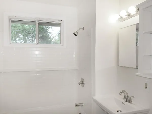 a bathroom with a sink and a window