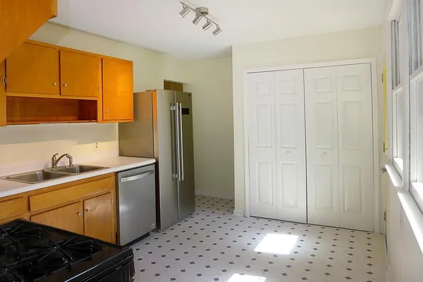 a kitchen with stainless steel appliances a refrigerator and a sink