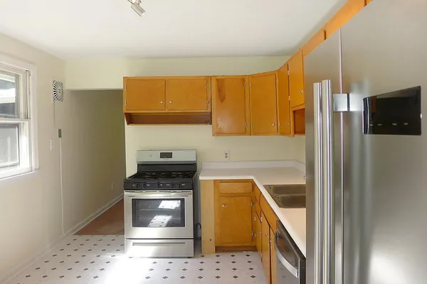 a kitchen with a sink a stove and cabinets