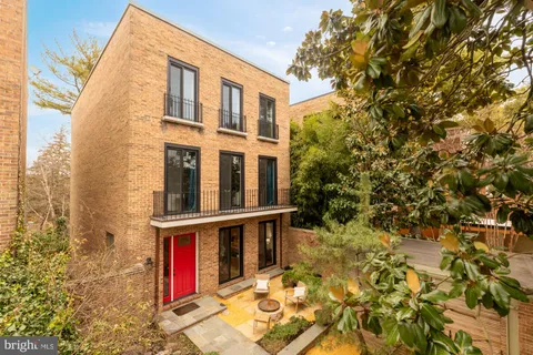 a view of a house with wooden fence