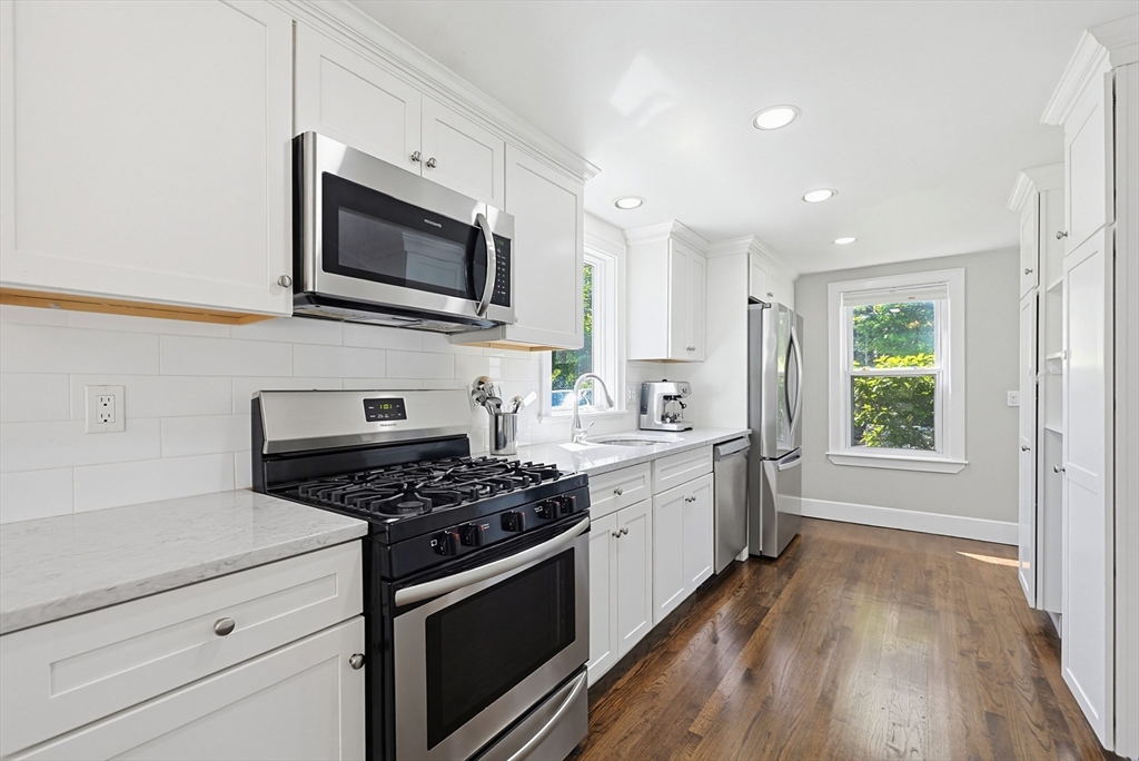 345 Sherman Street Canton, MA 02021 - Photo 8 of 42 a kitchen with stainless steel appliances a stove microwave and sink