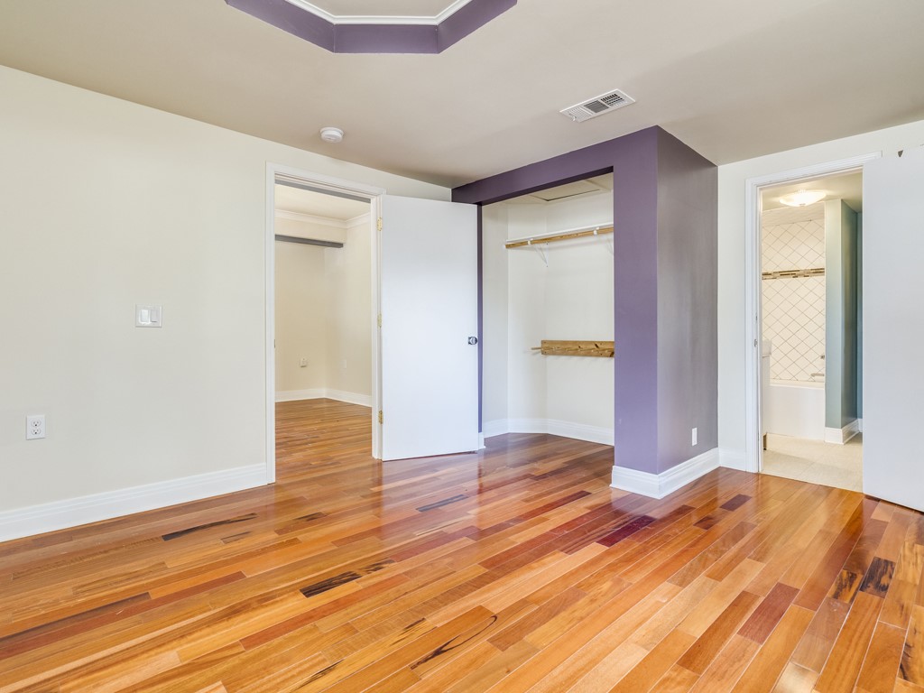 2314 Santa Rosa Street Austin, TX 78702 - Photo 10 of 27 Unfurnished bedroom with light wood-style floors, a closet, and ensuite bath