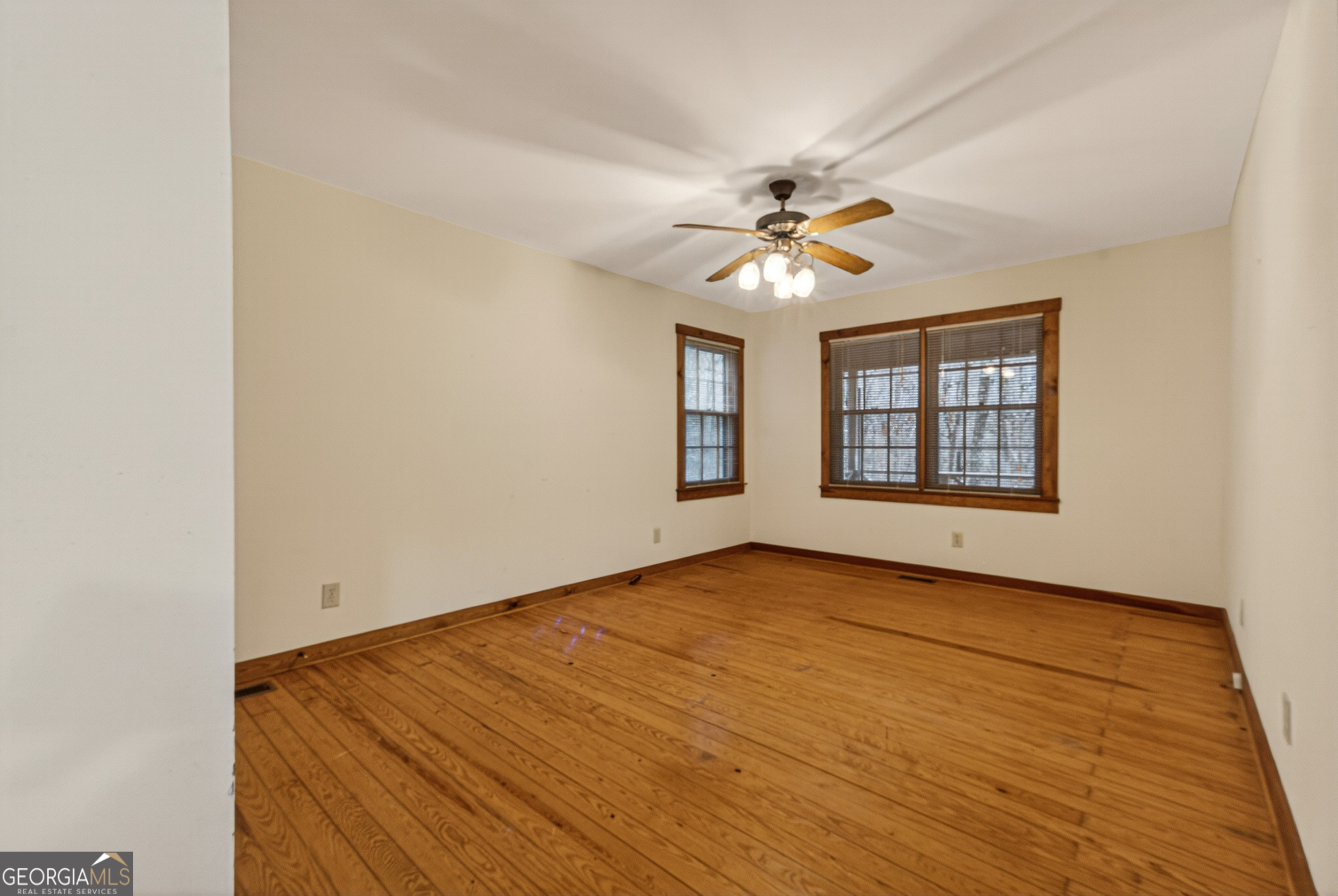 1165 Sparks Branch Road Hiawassee, GA 30546 - Photo 20 of 31 an empty room with windows and chandelier fan