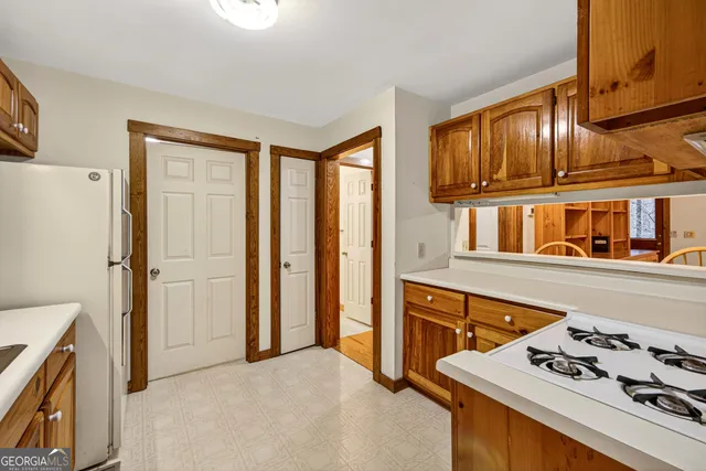 a kitchen with stainless steel appliances granite countertop a refrigerator and a stove top oven