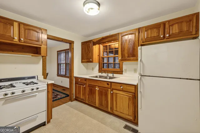 a kitchen with stainless steel appliances granite countertop a refrigerator and a stove top oven