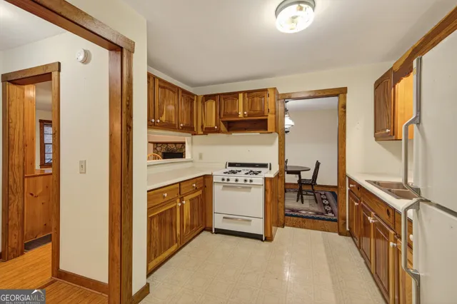 a kitchen with stainless steel appliances granite countertop a refrigerator and a stove top oven