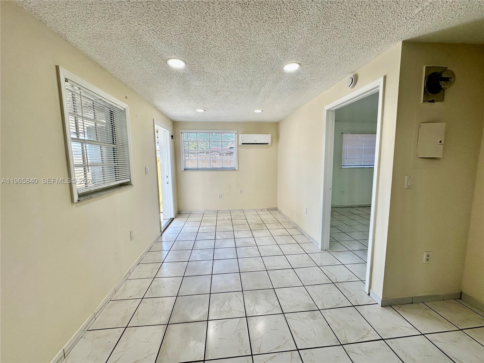 666 West 17th Street, Unit 3 Hialeah, FL 33010 - Photo 2 of 10 a view of an empty room and window