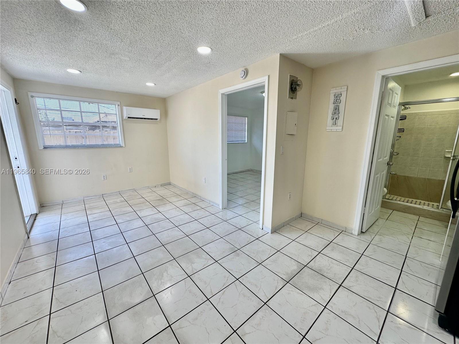 666 West 17th Street, Unit 3 Hialeah, FL 33010 - Photo 3 of 10 a view of an empty room and window