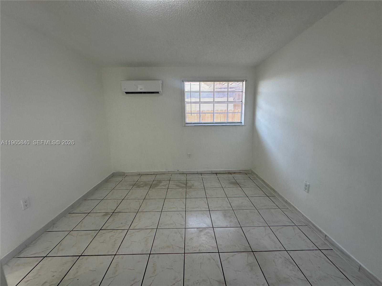 666 West 17th Street, Unit 3 Hialeah, FL 33010 - Photo 4 of 10 a view of an empty room and window