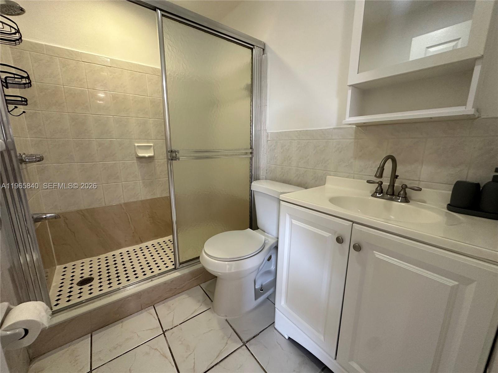666 West 17th Street, Unit 3 Hialeah, FL 33010 - Photo 8 of 10 a bathroom with a sink a toilet and shower