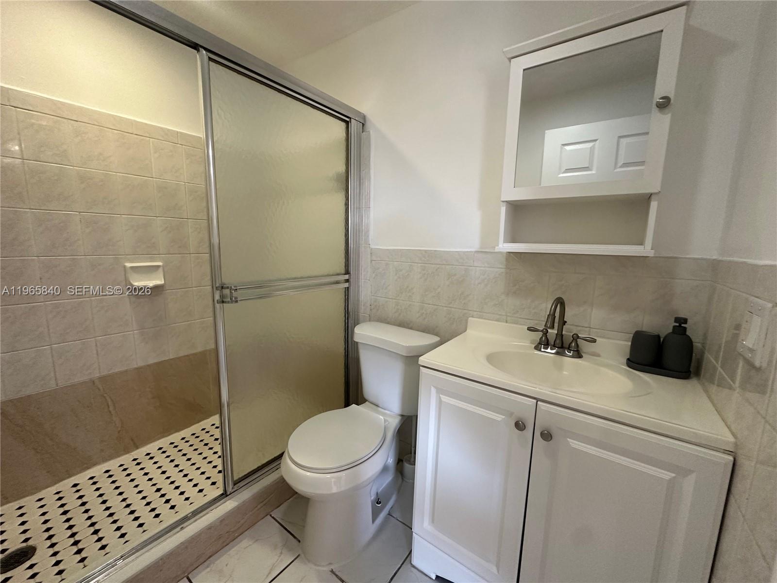 666 West 17th Street, Unit 3 Hialeah, FL 33010 - Photo 9 of 10 a bathroom with a sink a toilet and shower