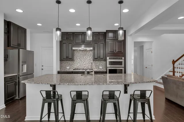 a spacious bedroom with a bed a table and a window