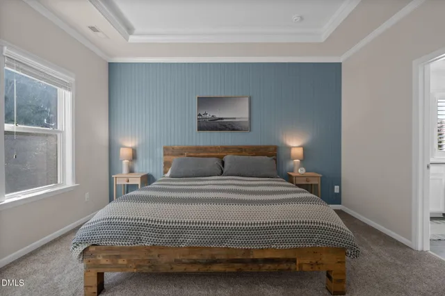 a living room with furniture a flat screen tv and kitchen view