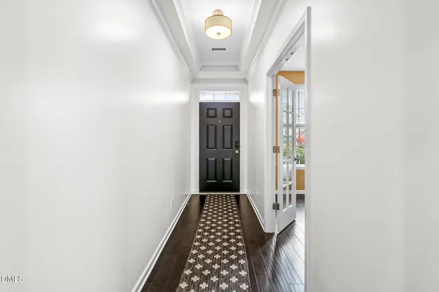 a view of a hallway with wooden floor and staircase