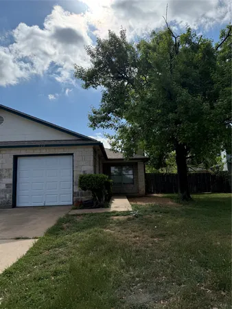 a front view of house with yard and trees