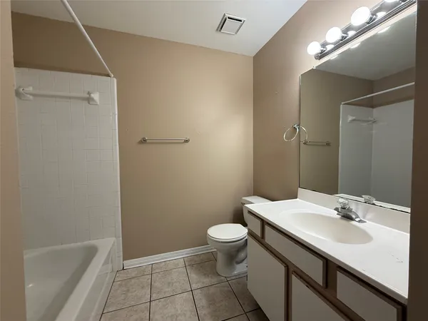 a bathroom with a sink a toilet a mirror and shower
