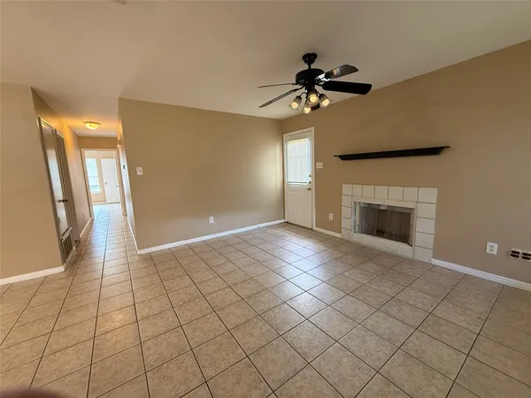a view of an empty room with a fireplace