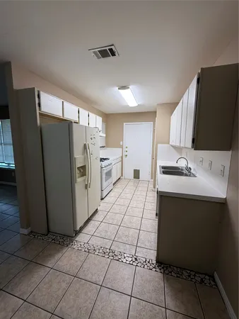 a kitchen with stainless steel appliances a refrigerator sink and microwave