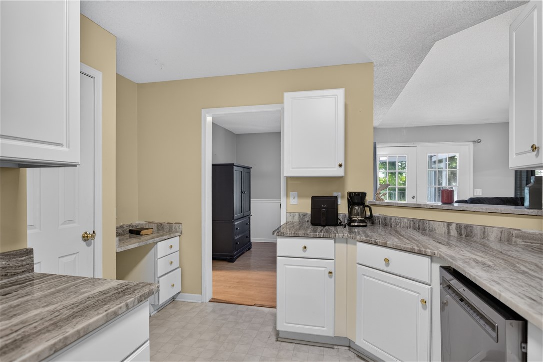 3336 Centerville Road Anderson, SC 29625 - Photo 19 of 50 A well-appointed kitchen features ample counter space, bright cabinetry, and a view into the adjacent living area with French doors.