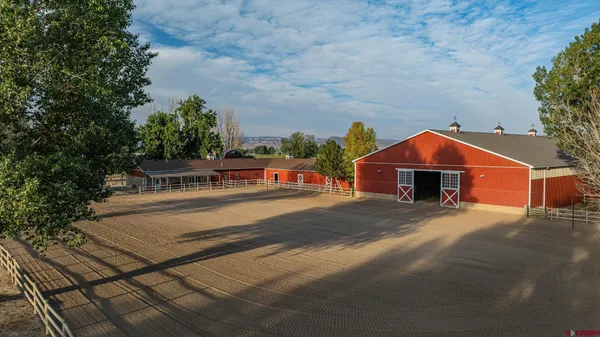 a view of a house with a wooden bench