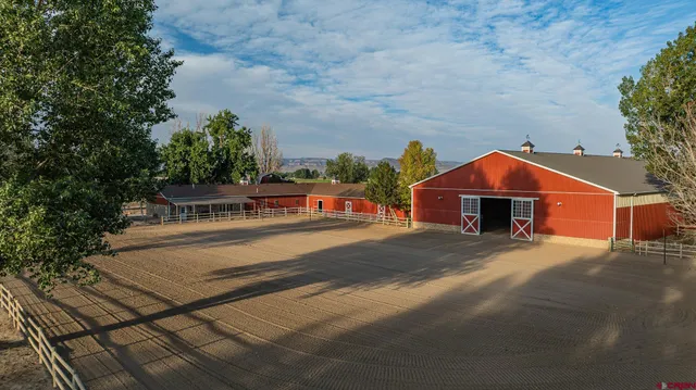 a view of a house with a wooden bench