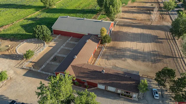 an aerial view of a house with outdoor space and a lake view in back