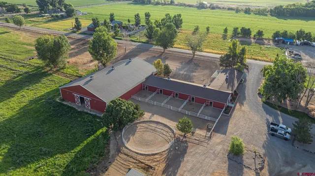 an aerial view of a house with a garden and lake view