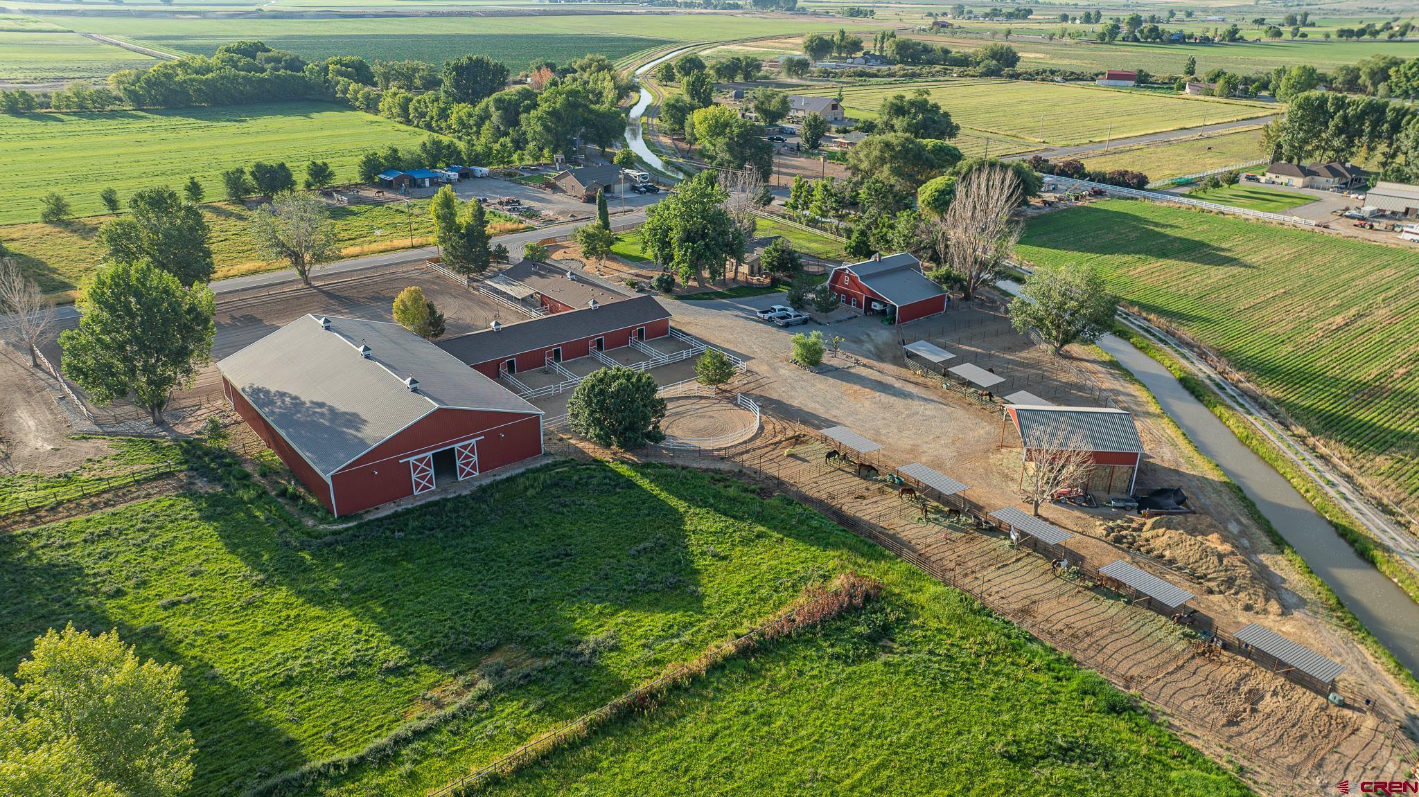 1577 14 1/2 Road Loma, CO 81524 - Photo 21 of 44 an aerial view of a house with a garden and lake view