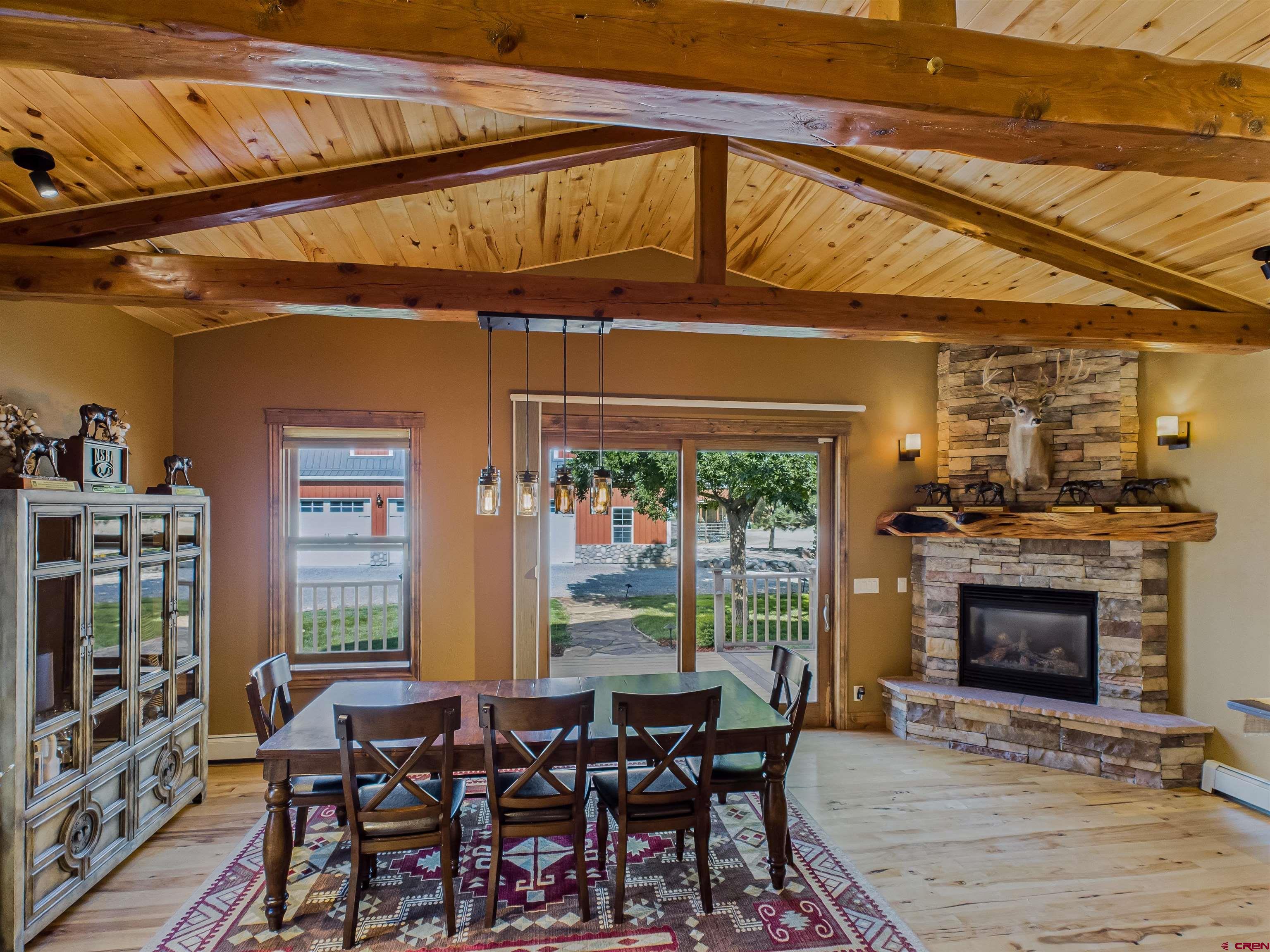 1577 14 1/2 Road Loma, CO 81524 - Photo 24 of 44 a dining room with furniture a fireplace and wooden floor