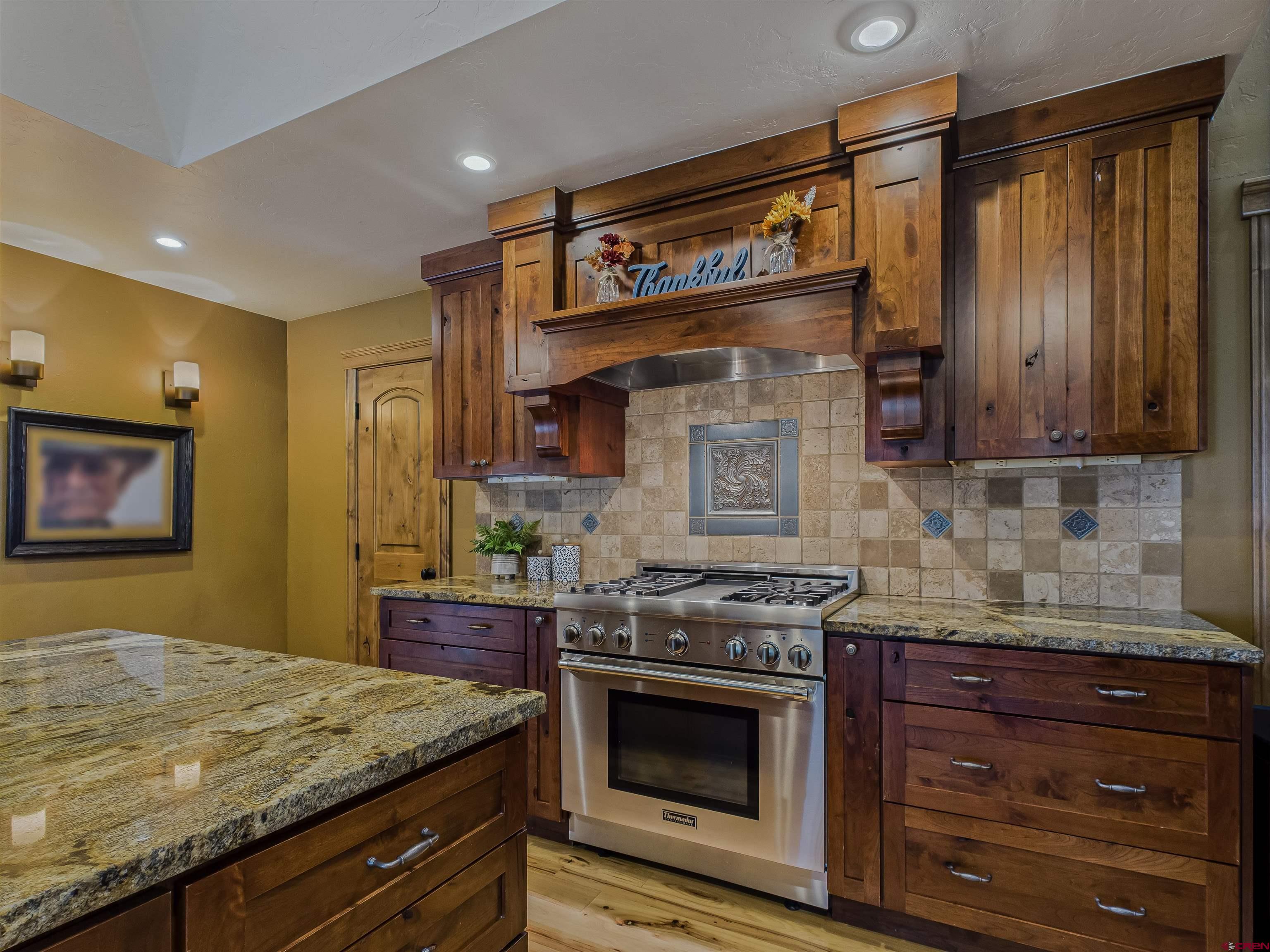 1577 14 1/2 Road Loma, CO 81524 - Photo 26 of 44 a kitchen with stainless steel appliances granite countertop a stove a sink and a microwave