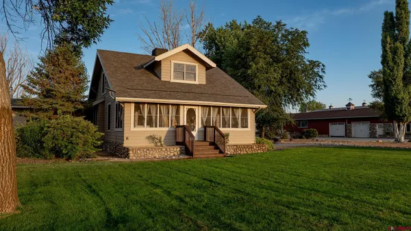 a front view of a house with a yard and porch