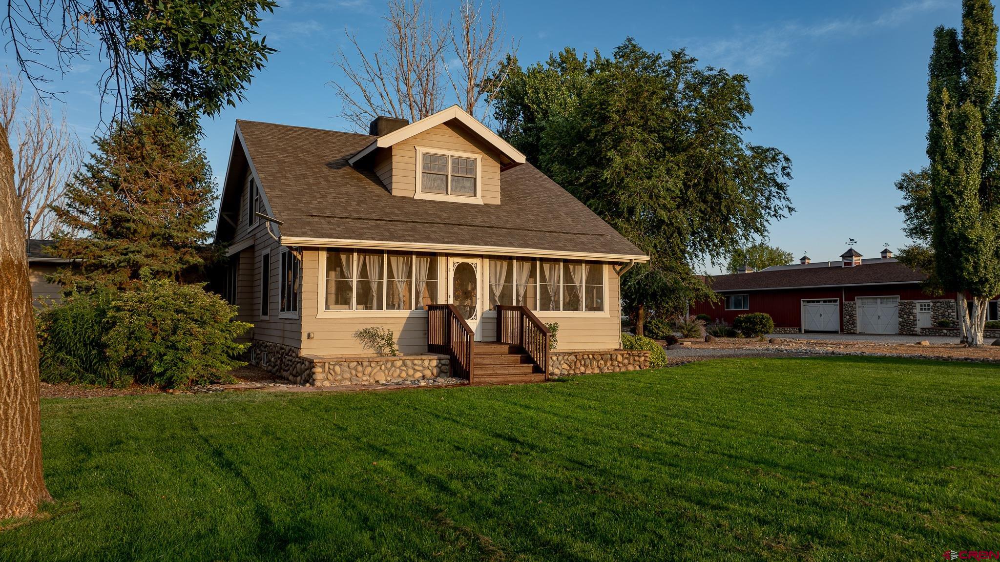 1577 14 1/2 Road Loma, CO 81524 - Photo 3 of 44 a front view of a house with a yard and porch