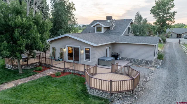 a view of a house with a patio and a garden