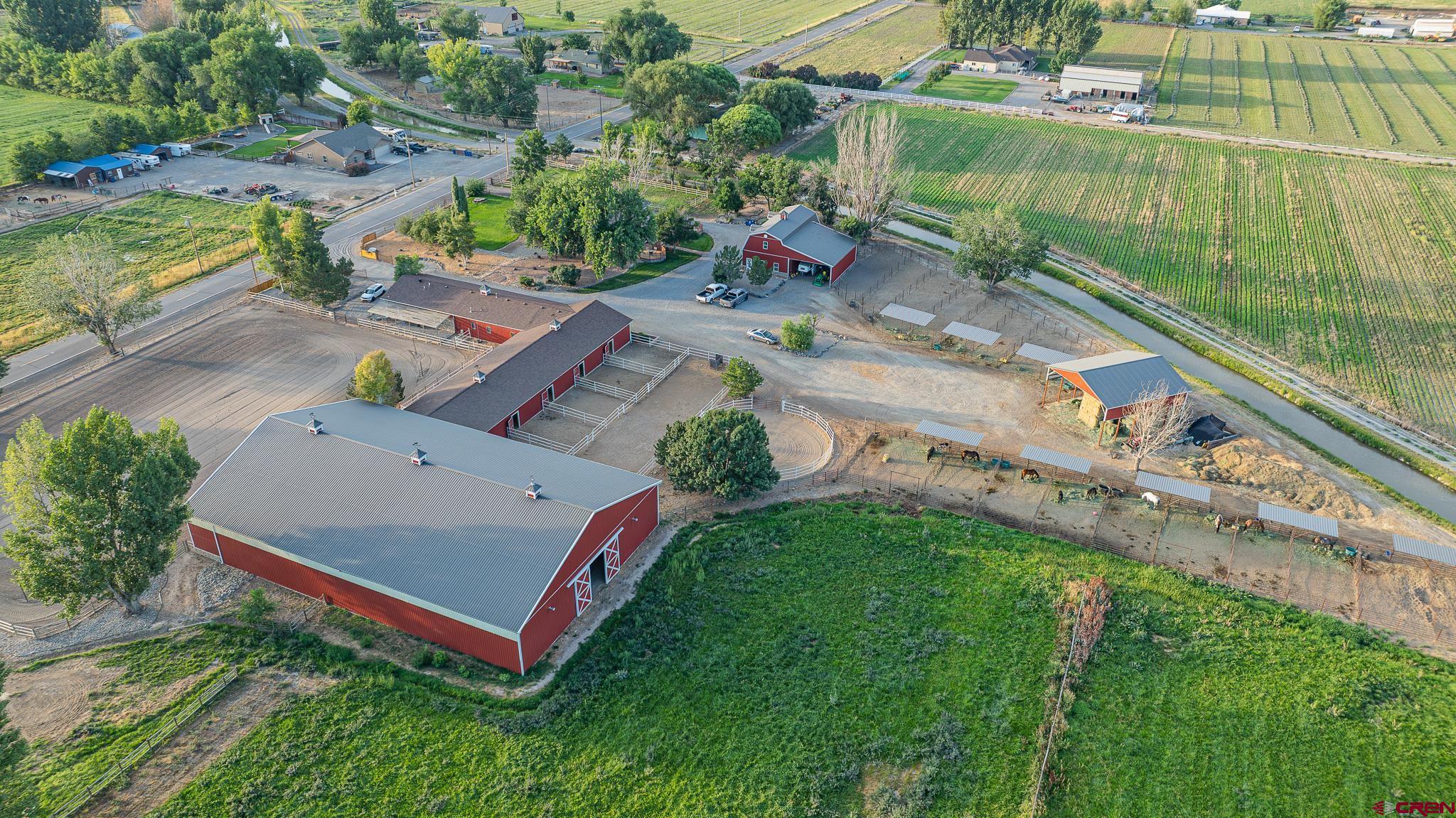 1577 14 1/2 Road Loma, CO 81524 - Photo 9 of 44 an aerial view of a house with a garden and trees
