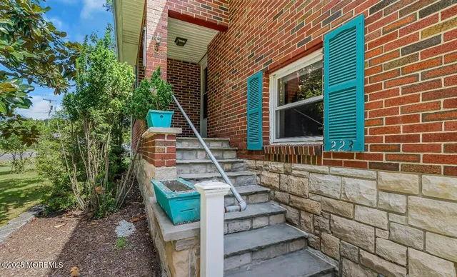 a pathway of a house with wooden fence
