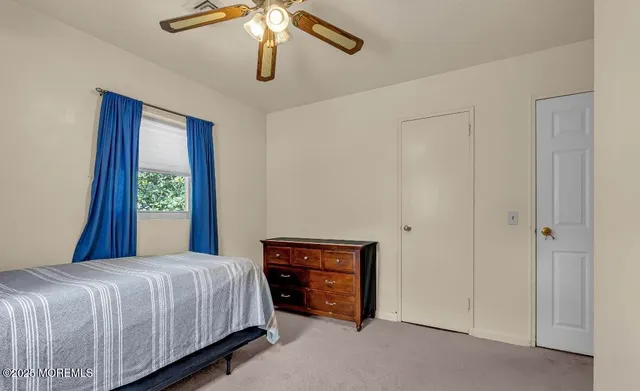 a view of a room with lounge chair and windows