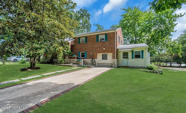 a view of a backyard with a garden and trees