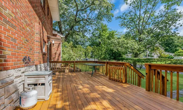 a view of balcony with wooden floor and seating space