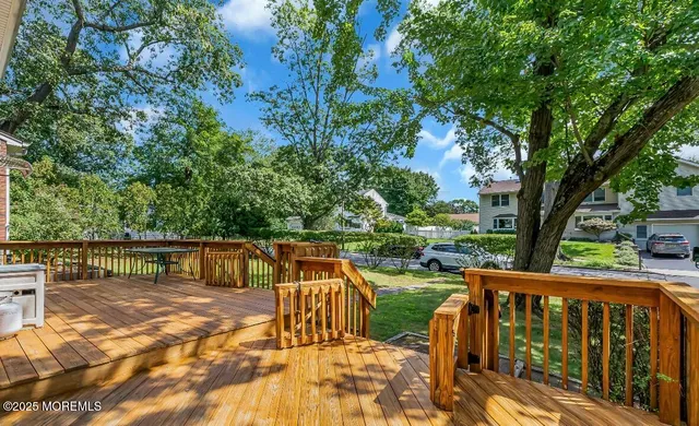 a view of balcony with two chairs and wooden fence