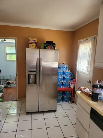 a kitchen with a refrigerator and a sink