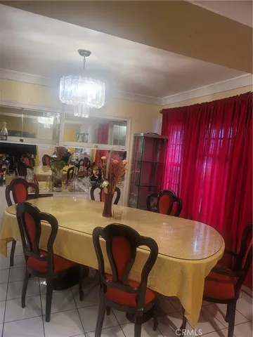 a view of a dining room with furniture and chandelier