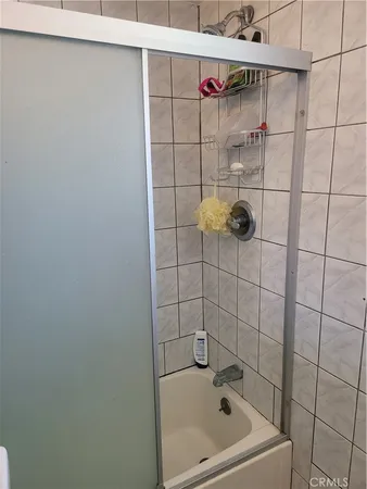 a bathroom with a bathtub and a shower