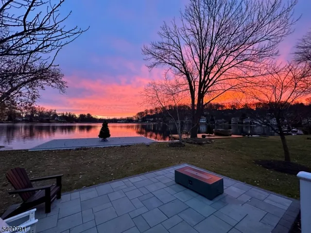 a park view with a table under an umbrella