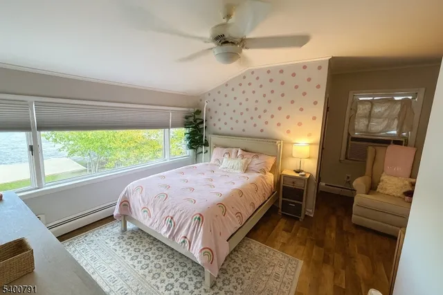 a bed sitting in a bedroom next to a window