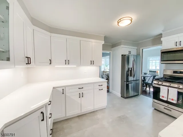 a kitchen with cabinets and stainless steel appliances