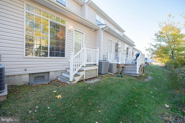 a view of a dining room with furniture and a chandelier
