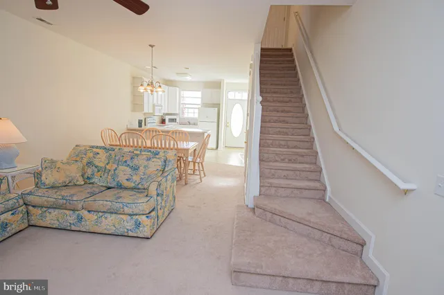 a bed sitting in a bedroom next to a window and a chandelier
