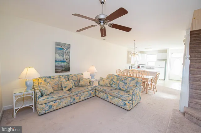 a spacious bedroom with a bed and a chandelier