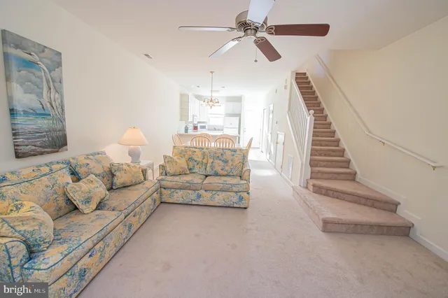 a spacious bedroom with a bed and a chandelier