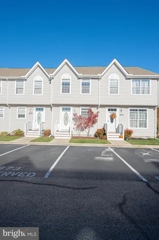 a view of a house with a yard and deck